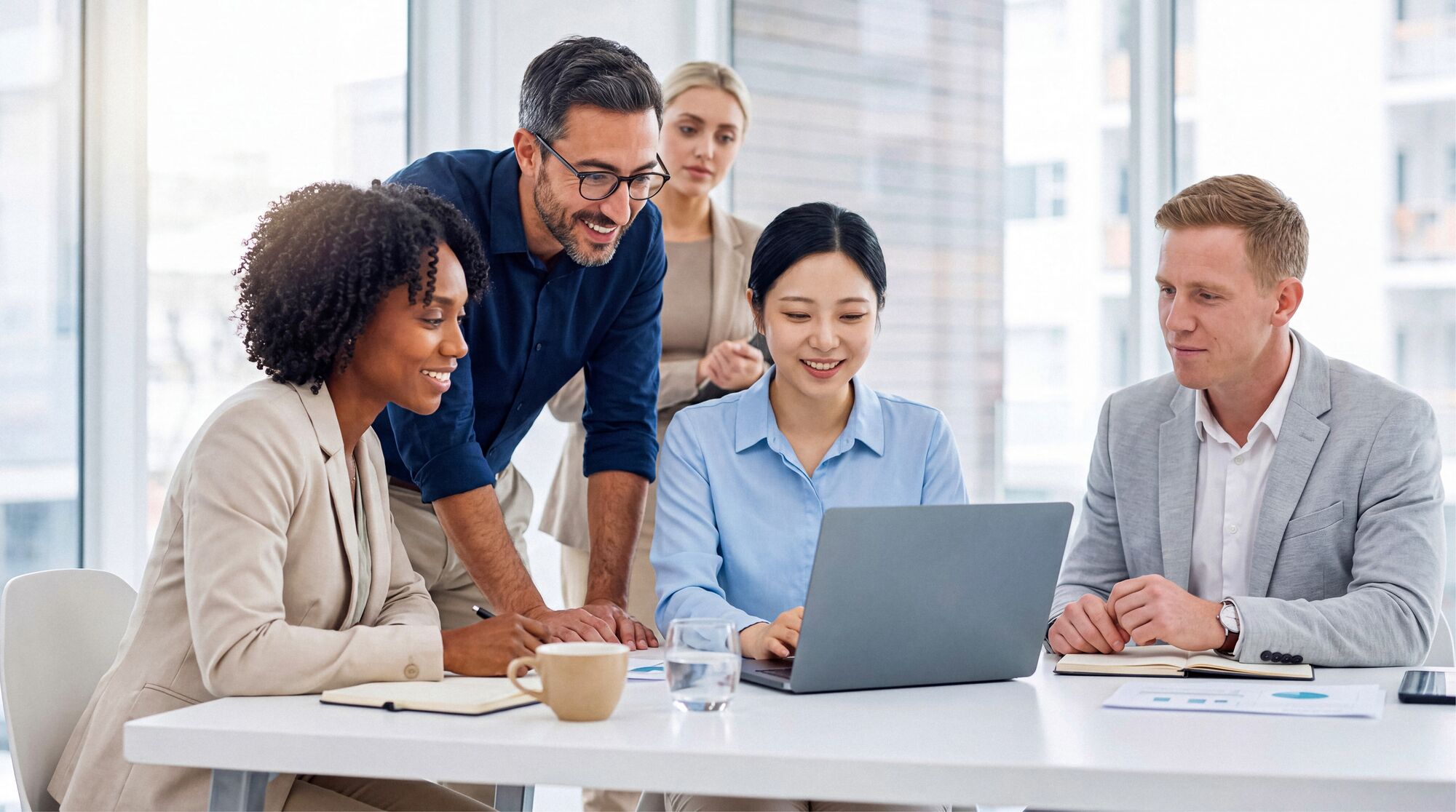 Business colleagues reviewing work together at a bright office table